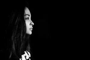 Mysterious Dark-haired Girl Gazing To The Right Wallpaper