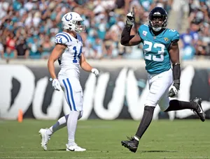 N F L Players On Field During Game Wallpaper