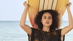 Nathalie Emmanuel With Surfboard Wallpaper