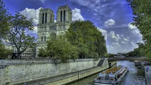 Notre Dame Cathedral With Boat Along The Seine Wallpaper