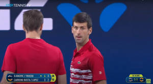 Novak Djokovic And Victor Troicki In Competitive Action Wallpaper