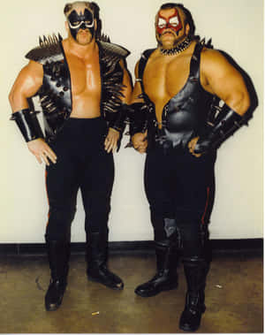 Nwa Champions - Road Warrior Hawk And Road Warrior Animal In Action Wallpaper