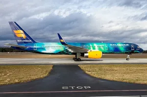 Ocean Blue Icelandair Airplane On Runway Wallpaper
