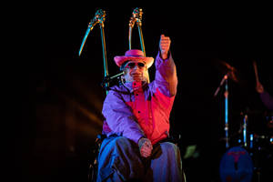 Oliver Tree Seated On Wheelchair Wallpaper