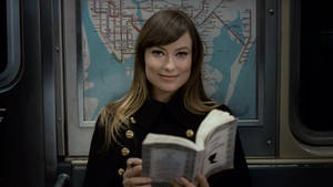 Olivia Wilde Holding A Book Wallpaper