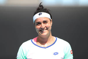 Ons Jabeur, The Successful Tunisian Tennis Star, Lights Up The Court With Her Radiant Smile Wallpaper