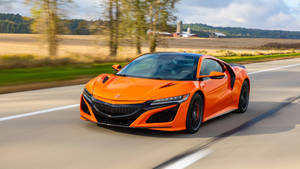 Orange Acura Car On Road Wallpaper