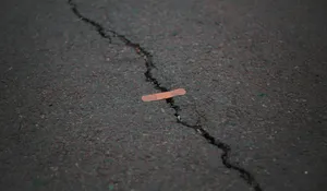 Orange Band Aid On Concrete Surface Crack Wallpaper