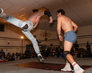 Orange Cassidy Delivering A Superman Punch In Pro Wrestling Match Wallpaper