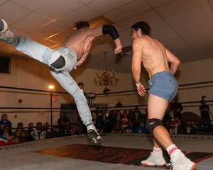 Orange Cassidy Delivering A Superman Punch In Pro Wrestling Match Wallpaper