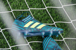 Pair Of Blue-black-and-beige Adidas Cleats Wallpaper