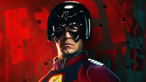 Peacemaker Superhero In An Action-packed Pose. Wallpaper