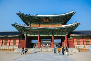 People Entering And Exiting Gyeongbokgung Palace Wallpaper