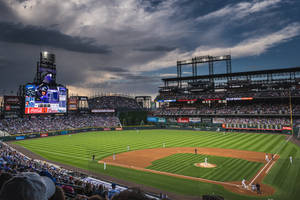 People In Sports Stadium Watching Baseball Game Wallpaper