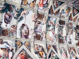 People In White And Brown Concrete Building Wallpaper