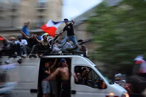 People Riding In And On Top Of Panel Van During Day Wallpaper