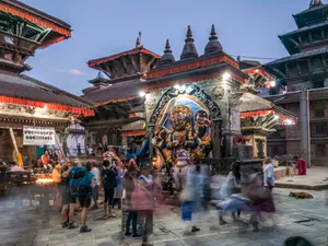 People Standing In Front Of Religious Statue Under Blue Sky Wallpaper