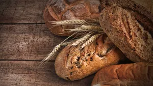 Perfectly Toasted Bread With Raw Wheat Spikes Wallpaper