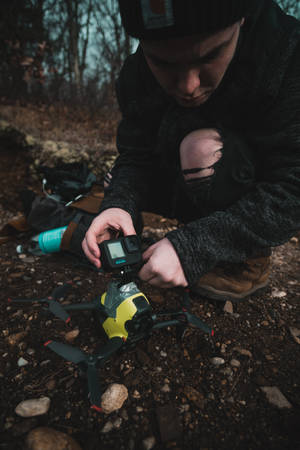 Person Attaching A Gopro To A Drone Wallpaper