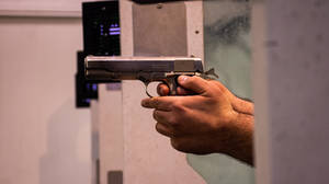 Person Holding Black And Silver Semi Automatic Pistol Wallpaper