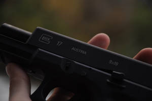 Person Holding Black Semi Automatic Pistol Wallpaper