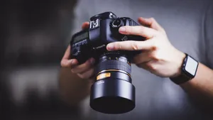 Person Holding Canon Dslr Camera Wallpaper