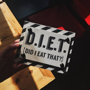 Person Holding Diet Quote Board Wallpaper