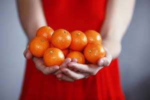 Person Holding Orange Fruits Wallpaper