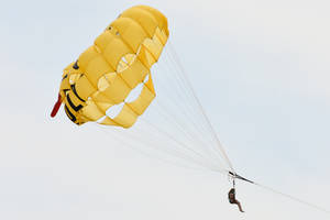 Person Parasailing In The Sky Wallpaper