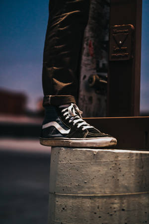 Person Stepping On Edge Of Concrete Pillar Wallpaper