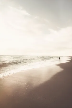 Person Walking On Beach During Daytime Wallpaper