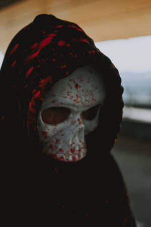 Person Wearing White Mask And Red And Black Scarf Wallpaper