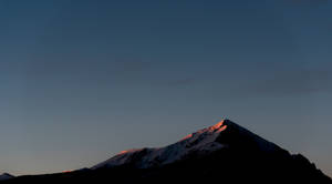 Picturesque Mountain Range With Clouds And The Horizon Beyond Wallpaper