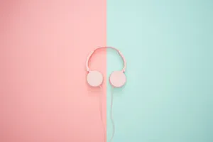 Pink Headphones On A Pink And Blue Background Wallpaper