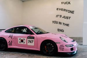 Pink Sedan Showcasing Anti Social Club Logo Wallpaper