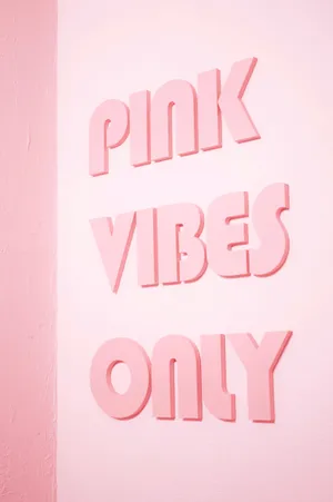 Pink Vibes Only - A Pink Wall With Pink Letters Wallpaper