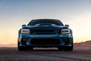 Powerful Dodge Charger Cruising Down The Highway Wallpaper