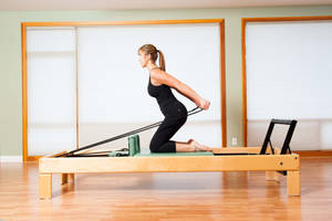 Powerful Lady Practicing Pilates Wallpaper