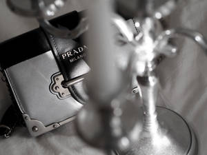 Prada Sling Bag On Table Wallpaper