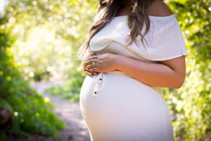 Pregnant Belly White Dress Outside Wallpaper