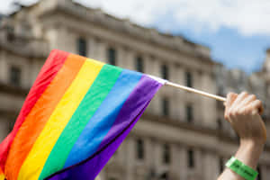 Pride Flag Waving During Parade.jpg Wallpaper