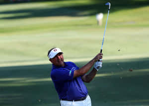 Professional Golfer Ken Duke Swings His Club On The Golf Course Wallpaper