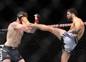Professional Mma Fighter, Nassourdine Imavov, Skillfully Defending A Kick During A Match. Wallpaper