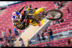 Professional Motocross Rider Ken Roczen Taking A Speed Turn Wallpaper