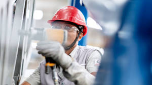 Professional Technician Maintaining Industrial Equipment Wallpaper