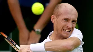 Professional Tennis Player Nikolay Davydenko Squinting In The Sun Wallpaper
