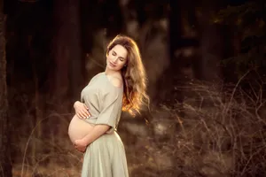 Radiant Expecting Mother With Baby Bump Wallpaper