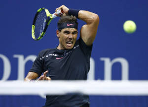 Rafael Nadal Powerfully Swinging His Racket Wallpaper