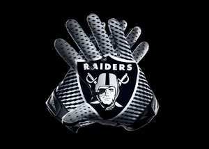 Raiders Logo On Striped Football Gloves Wallpaper