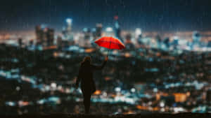 Rainy Cityscape Umbrella Moment.jpg Wallpaper